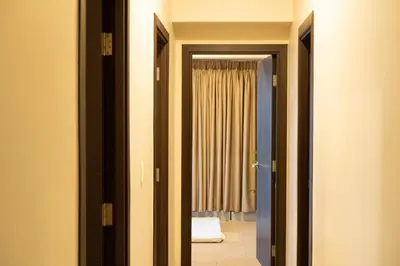 a hallway with a door leading to a bedroom at BGC 3BR Uptown Parksuites with bathtub 16 in Manila