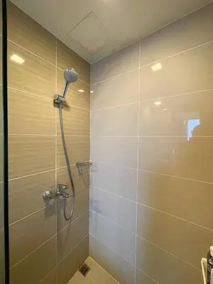 a shower with a shower head in a bathroom at BGC 2BR Uptown Parksuites with PS4 43 in Manila