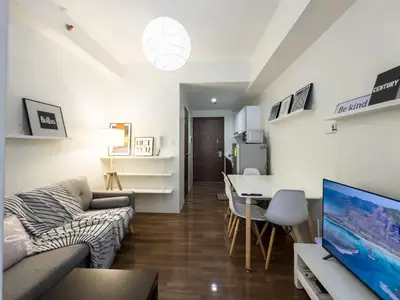 a living room with a couch and a table at GemstoneBR II@SMDC Air Residences in Manila