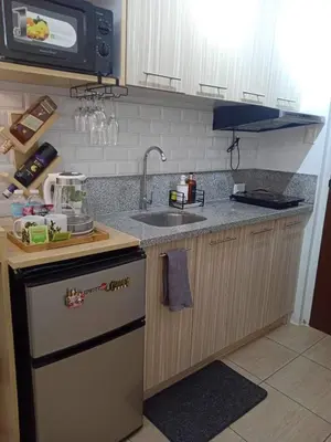 a kitchen with a sink and a counter top at ALABANG STUDIO unit w/ high speed Fiber WIFI in Manila