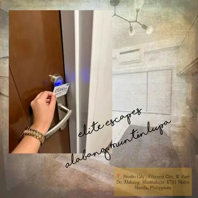 a hand is unlocking a refrigerator with a door at ALABANG STUDIO unit w/ high speed Fiber WIFI in Manila