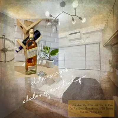 a bottle of whiskey sitting on a table with a glass at ALABANG STUDIO unit w/ high speed Fiber WIFI in Manila