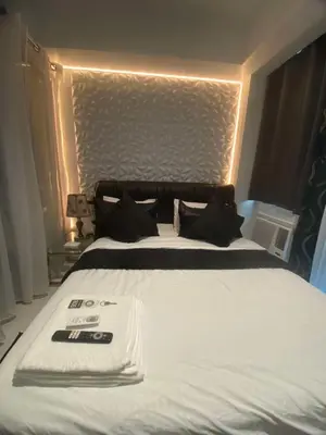 a large white bed with a white towel on it at Azure 1BR citylights with netlfix near airport in Manila