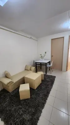 a living room with a couch and a table at URBAN DECA Homes SM EAST Pasig in Manila