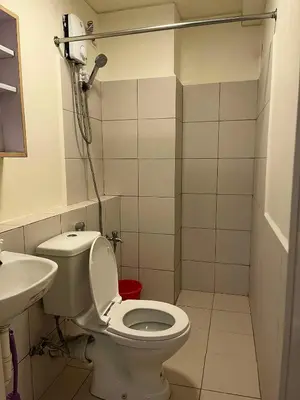 a small bathroom with a toilet and a sink at URBAN DECA Homes SM EAST Pasig in Manila