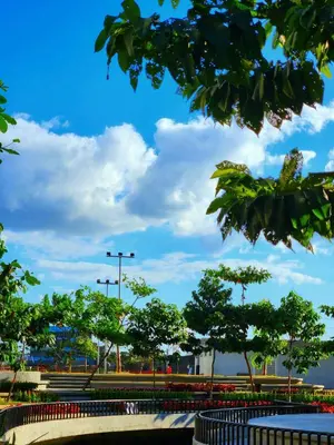 a park with trees and a blue sky with clouds at URBAN DECA Homes SM EAST Pasig in Manila