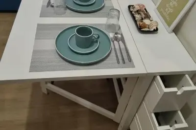 a table with two plates and a coffee cup on it at Bicutan Urban Haven in Manila