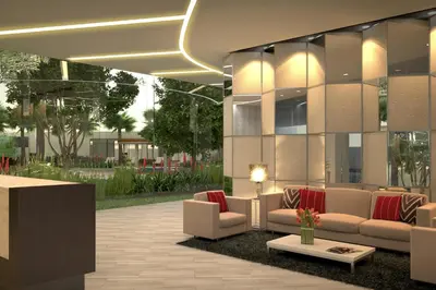 a lobby with couches and tables in a building at Bicutan Urban Haven in Manila