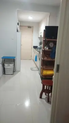 a kitchen with a white floor and a refrigerator at S Residences in Manila