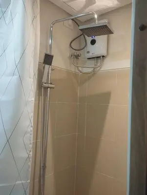 a shower with a shower head in a bathroom at S Residences in Manila