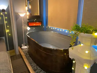 a bath tub in a bathroom with christmas lights at EL MEIR PRIME CABIN w/ Bathtub near EK in Santa Rosa