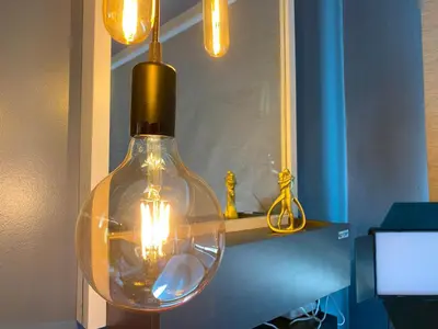 a glass light bulb hanging from a ceiling with lights at EL MEIR PRIME CABIN w/ Bathtub near EK in Santa Rosa