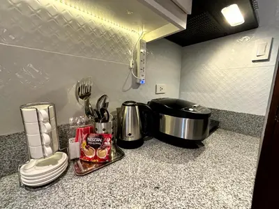 a kitchen counter with a sink and a stove at Casa Del Hasmin in Puting Kahoy