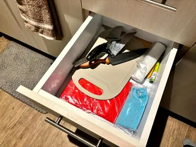 a drawer in a cabinet with a pair of scissors at Casa Del Hasmin in Puting Kahoy