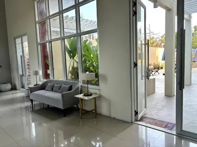 a living room with a couch and a table at Casa Del Hasmin in Puting Kahoy