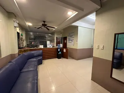 a waiting room with a couch and a ceiling fan at St John's Pearl Transient House in Manila