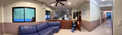 a waiting room with a blue couch in a building at St John's Pearl Transient House in Manila