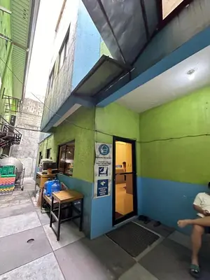 a small green and blue building with a door at St John's Pearl Transient House in Manila