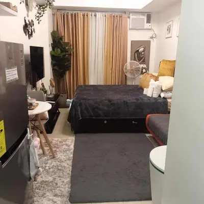 a bedroom with a bed and a living room at Luxury Resort Condo in Pasig FastWifiPoolSmartLock in Manila
