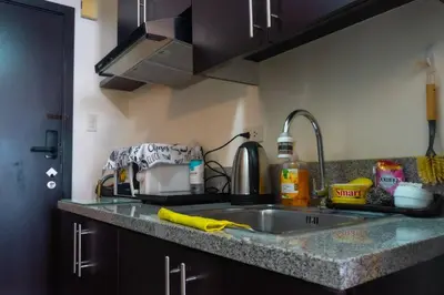 a kitchen with a sink and a counter top at Luxury Resort Condo in Pasig FastWifiPoolSmartLock in Manila