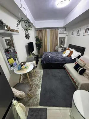 a bedroom with a bed and a living room at Luxury Resort Condo in Pasig FastWifiPoolSmartLock in Manila
