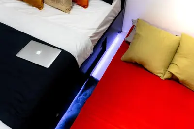 a bed with a laptop computer sitting on top of it at Luxury Resort Condo in Pasig FastWifiPoolSmartLock in Manila