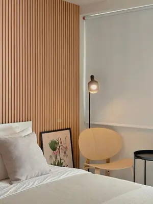 a bedroom with a bed and a table and a chair at Manila Staycation Rental in Manila