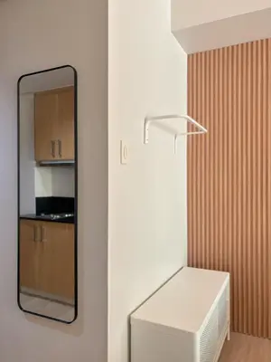 a mirror and a white refrigerator in a room at Manila Staycation Rental in Manila