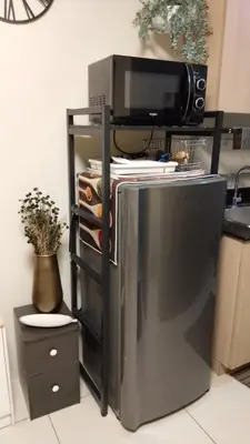 a stainless steel refrigerator with a microwave on top of it at Condo Near MOA, NAIA, PICC, & CCP that is comfy with a view! in Manila