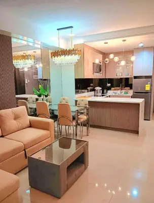 a living room with a couch and a table at California Suite - by GUEST RESERVATION'S MANILA in Manila