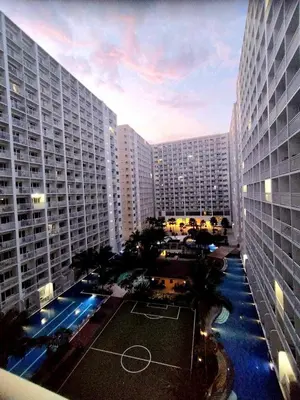 an aerial view of a large building with a basketball court at California Suite - by GUEST RESERVATION'S MANILA in Manila