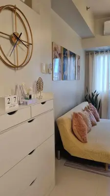 a bedroom with a bed and a clock on the wall at One bedroom with Balcony-M&M City Comfort in Manila