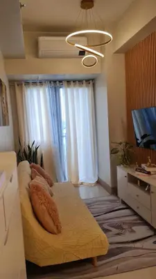 a living room with a couch and a television at One bedroom with Balcony-M&M City Comfort in Manila