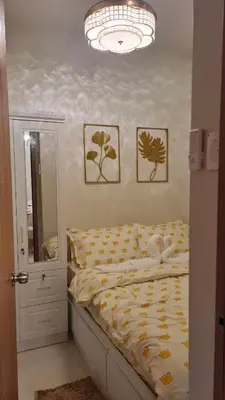 a bed in a bedroom with two pictures on the wall at One bedroom with Balcony-M&M City Comfort in Manila