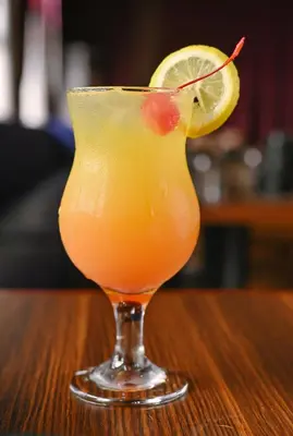 a drink sitting on a table with a lemon slice at Monaco Hotel in Taytay