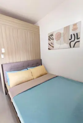 a small room with a bed in a room at Shatze's Place-One Bedroom Pool view near MOA and Airport in Manila