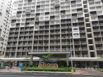 a large building with a store in front of it at Shatze's Place-One Bedroom Pool view near MOA and Airport in Manila