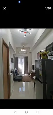 a kitchen and living room with a couch and a refrigerator at MOA Shore 3 tower 2 in Manila