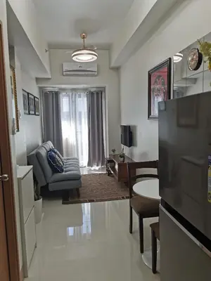 a living room with a couch and a chair at MOA Shore 3 tower 2 in Manila