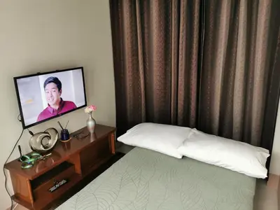 a bedroom with a bed and a tv on a table at MOA Shore 3 tower 2 in Manila