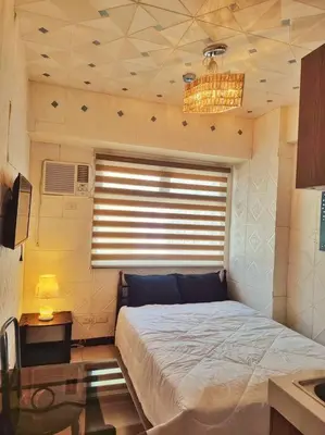 a bedroom with a bed and a window with a ceiling at Urban Deca EDSA Budget Place w/ Unli Wi-Fi Netflix in Manila