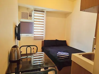 a small room with a bed and a sink at Urban Deca EDSA Staycation w/Unli Wi-Fi & Netflix in Manila