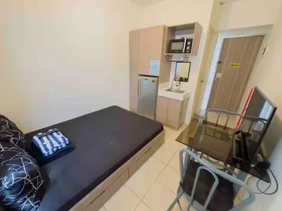 a small room with a table and a refrigerator at Urban Deca EDSA Staycation w/Unli Wi-Fi & Netflix in Manila