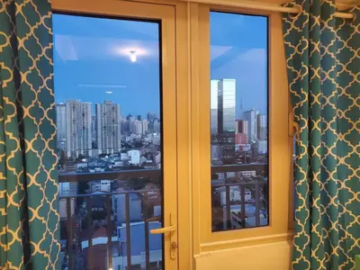 a window with a view of a city at COAST RESIDENCES in Manila