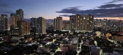 a city skyline at night with tall buildings at COAST RESIDENCES in Manila