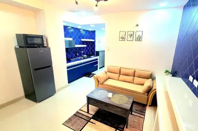 a small living room with a couch and a refrigerator at BGC Beautiful Large 1 Bedroom Condo Sleeps 3 Adults in Manila