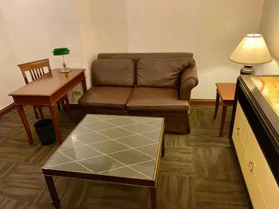 a living room with a couch and a table at Maharaja Oriental Suite Makati in Manila