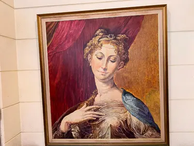 a painting of a woman on a wall at Maharaja Oriental Suite Makati in Manila