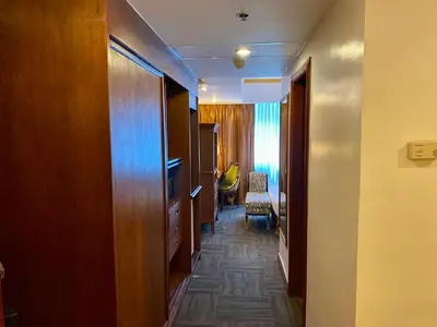 a corridor of a hotel room with a hallway at Maharaja Oriental Suite Makati in Manila