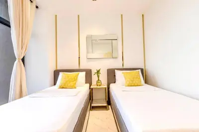 two beds sitting next to each other in a room at Kaiyana Apartments in Manila